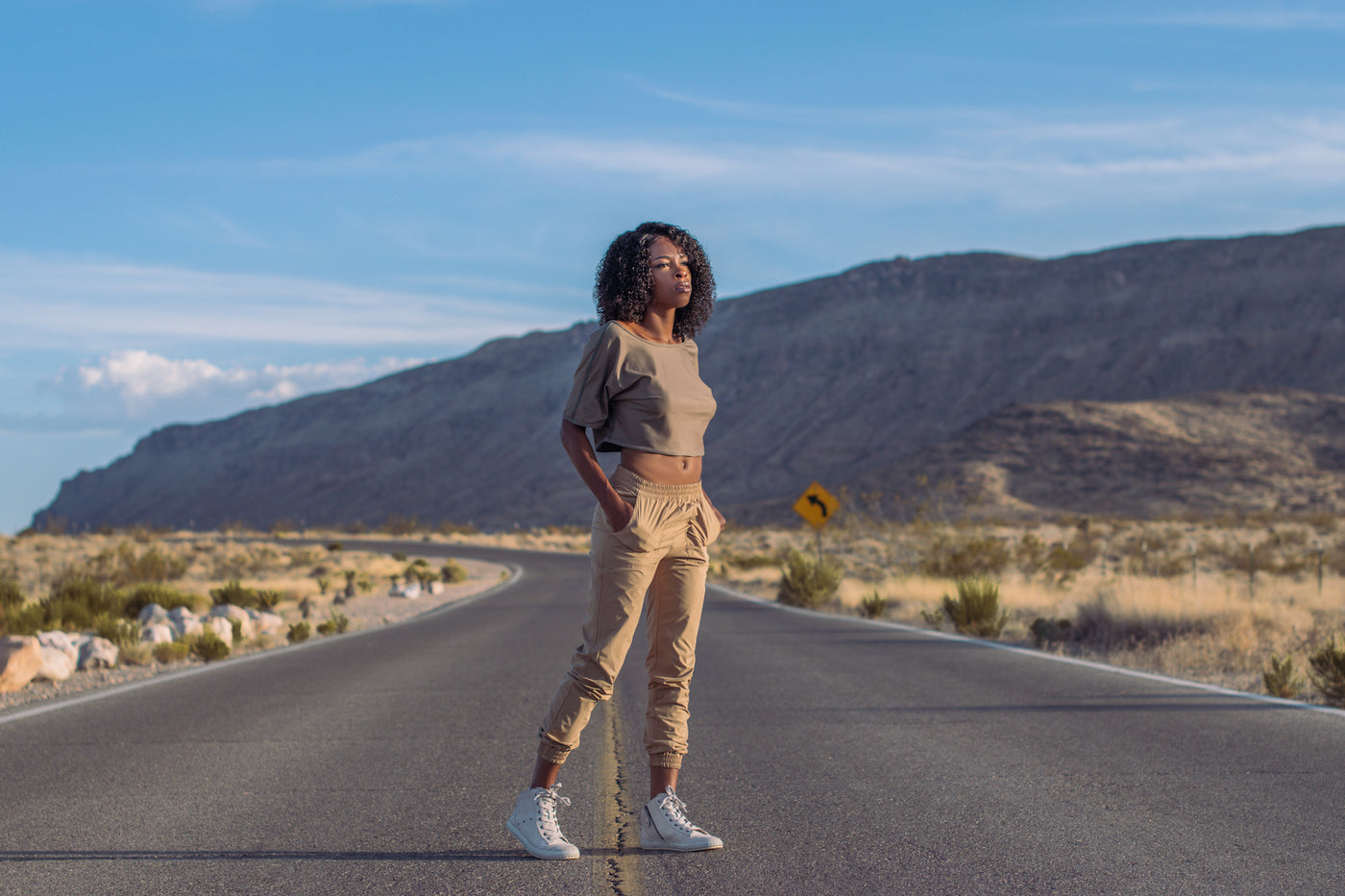 Woman looks into the sun standing in the middle of the desert wearing Splice Clothing Reversible Travel Clothing Phoenix Reversible Joggers in Las Vegas Nevada